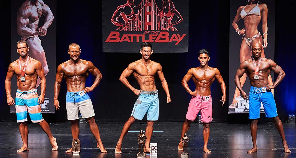 Body builder posing with their tropies
